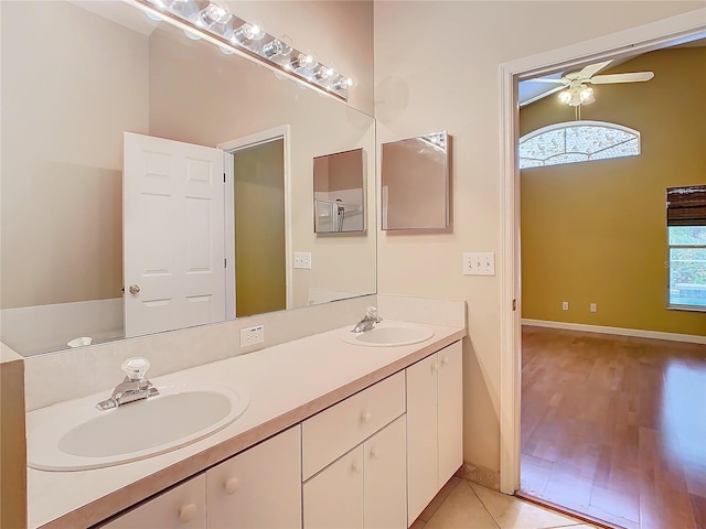 bathroom with ceiling fan, a wealth of natural light, and vanity