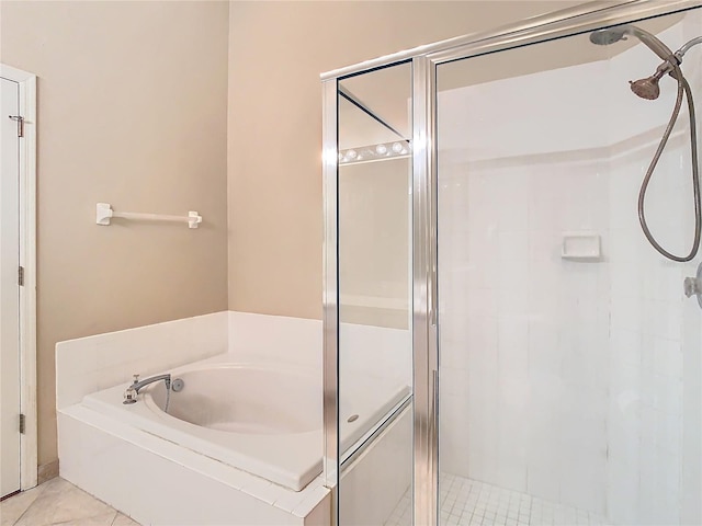 bathroom featuring tile patterned floors and separate shower and tub