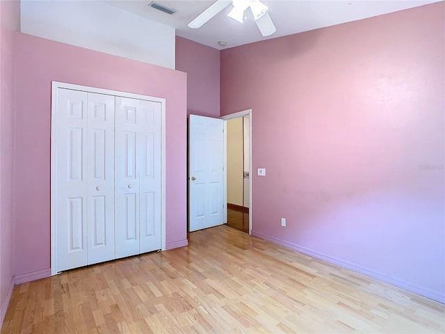 unfurnished bedroom featuring a closet, ceiling fan, and light wood-type flooring