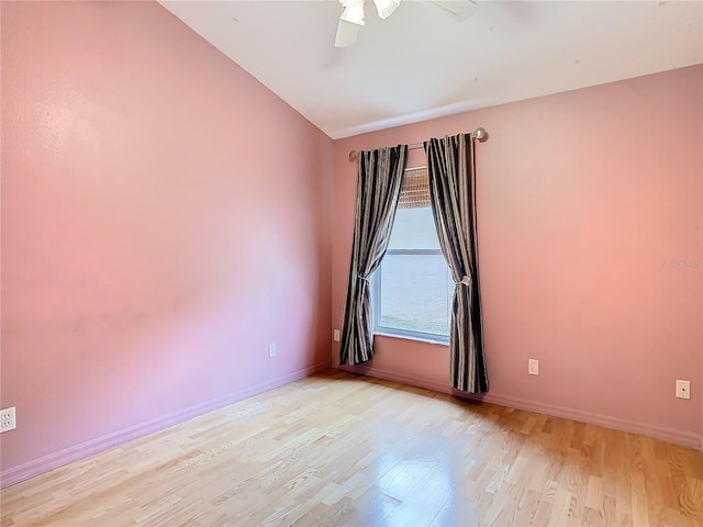 spare room with ceiling fan, light wood-type flooring, and lofted ceiling