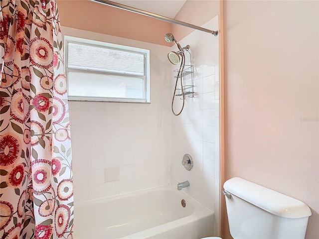 bathroom featuring toilet and shower / tub combo