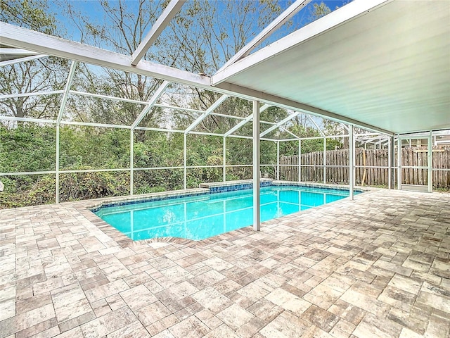 view of swimming pool with a patio area and glass enclosure