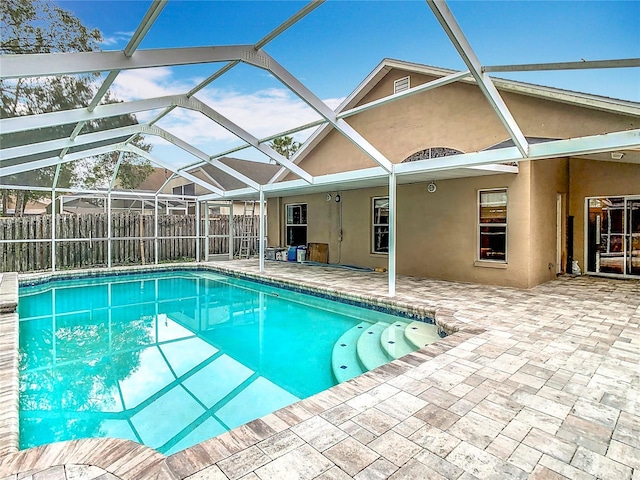 view of pool featuring a patio area and glass enclosure