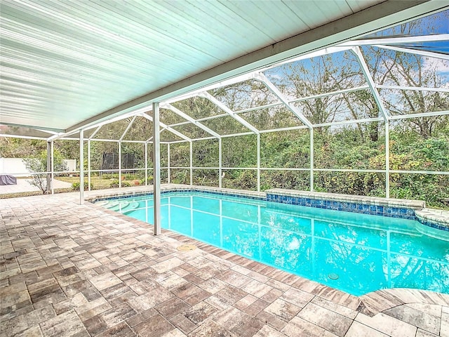 view of pool featuring a lanai and a patio