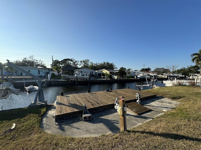 dock area featuring a lawn and a water view