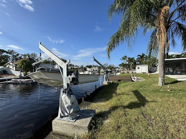 dock area with a yard and a water view