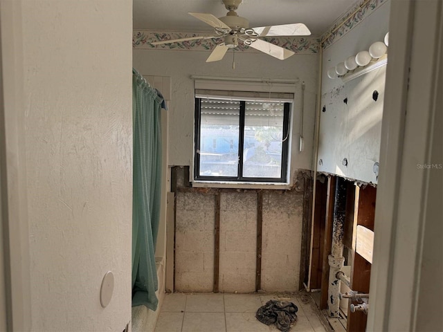 bathroom with curtained shower, ceiling fan, and tile patterned floors