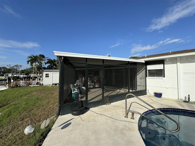 view of patio with a sunroom and a storage shed