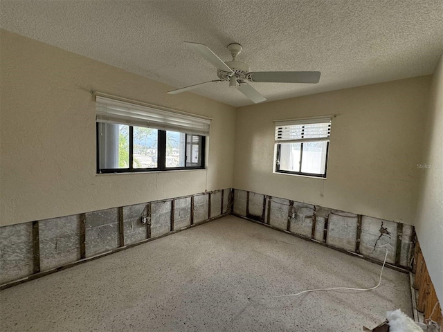 spare room featuring a textured ceiling and ceiling fan