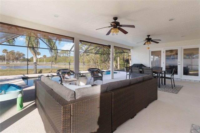 view of patio / terrace featuring french doors, a water view, an outdoor living space, and glass enclosure