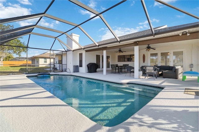 view of pool with ceiling fan, a patio, glass enclosure, central air condition unit, and an outdoor hangout area