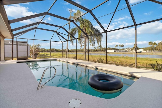 view of pool with a water view, glass enclosure, and a patio area