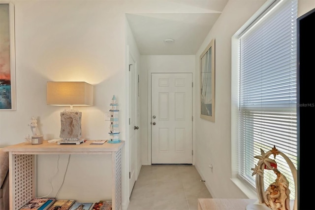 interior space with light tile patterned floors and a wealth of natural light