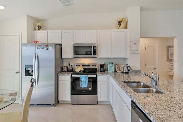 kitchen with white cabinets, stainless steel appliances, sink, and light tile patterned floors