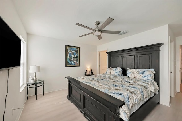 bedroom with ceiling fan and light hardwood / wood-style floors