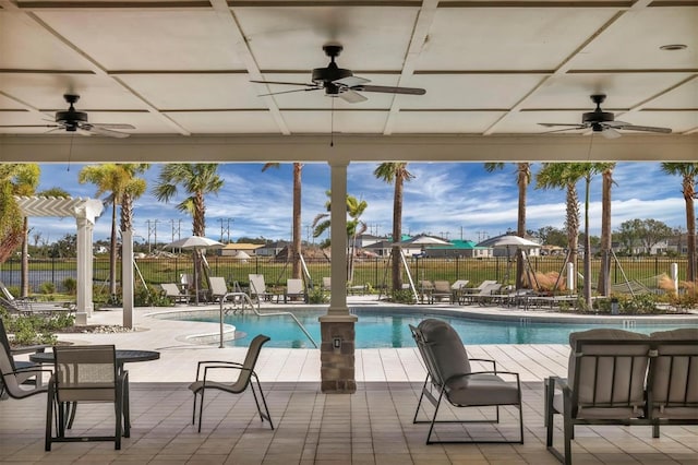 view of swimming pool featuring a patio area and ceiling fan