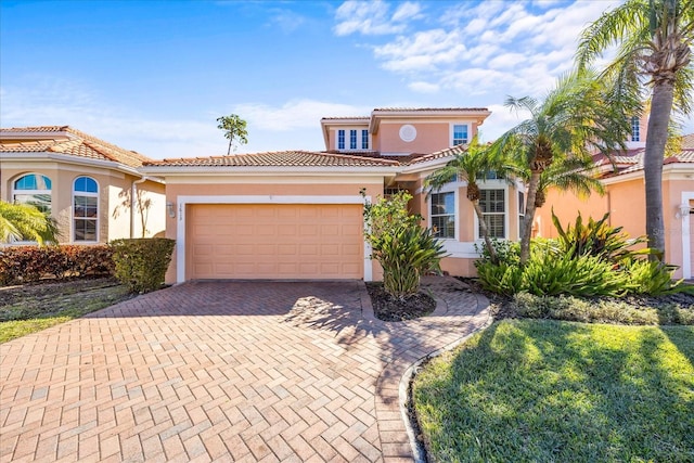 mediterranean / spanish house with a garage