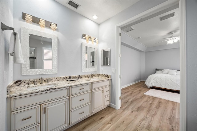 bathroom featuring vanity, hardwood / wood-style flooring, and ceiling fan