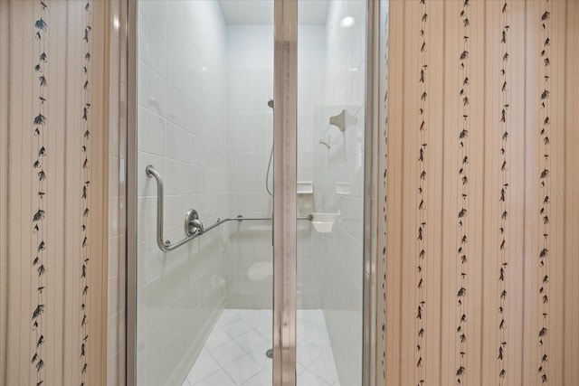 bathroom with a shower with door