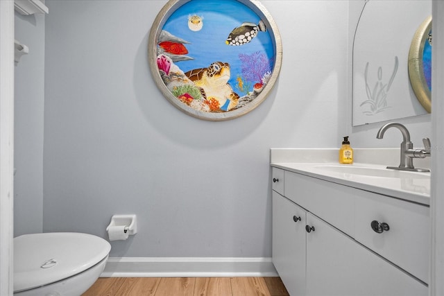 bathroom featuring vanity, hardwood / wood-style floors, and toilet