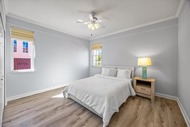 bedroom featuring ornamental molding, light wood-type flooring, and ceiling fan