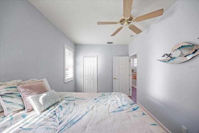 bedroom featuring ceiling fan and a closet