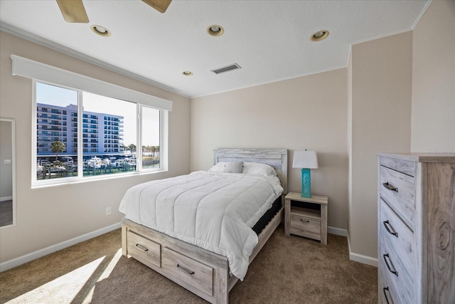 carpeted bedroom with crown molding and ceiling fan