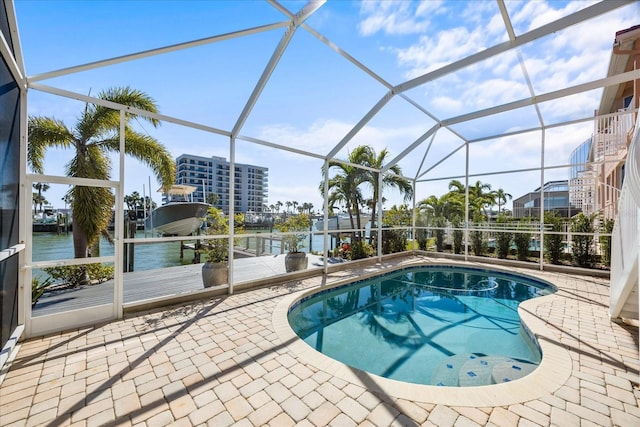 view of pool with a water view, a lanai, and a patio