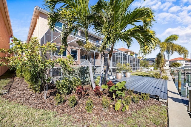 exterior space featuring a lanai and a dock