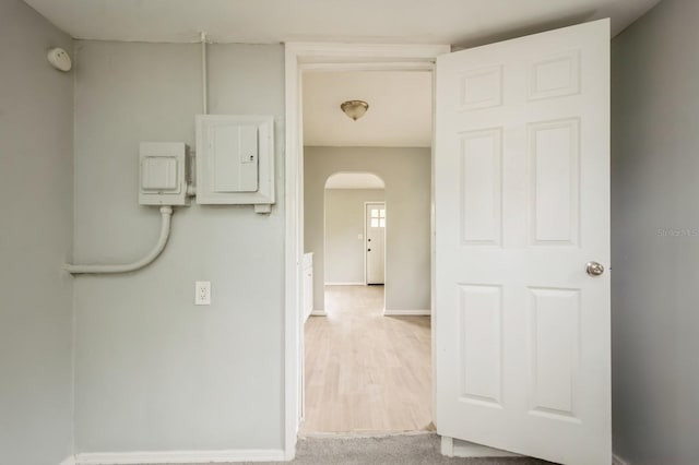 corridor with electric panel and carpet floors