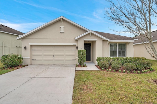 ranch-style home featuring a garage and a front yard