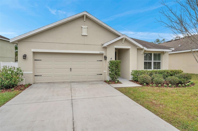 ranch-style house with a garage and a front yard