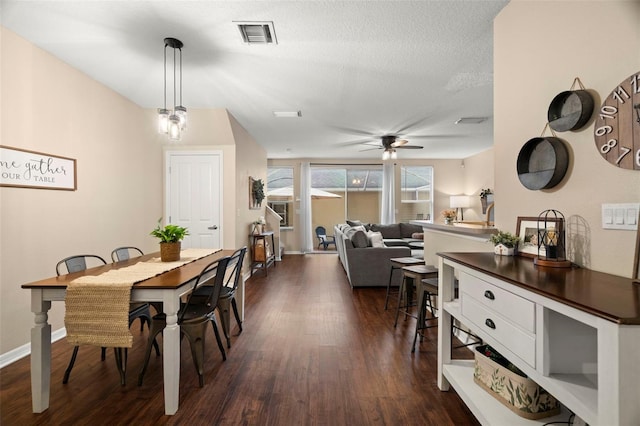 dining area featuring a textured ceiling, ceiling fan, and dark hardwood / wood-style floors