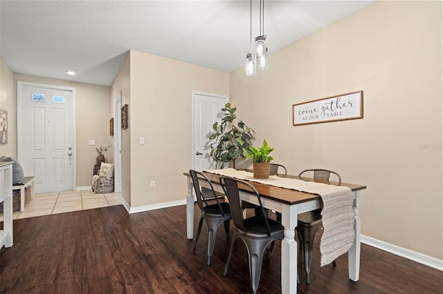 dining space featuring wood-type flooring