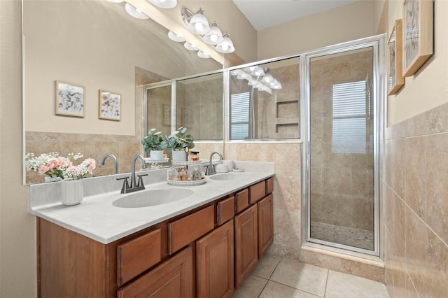 bathroom with a shower with door, tile patterned flooring, and vanity