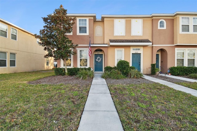 view of property featuring a front lawn