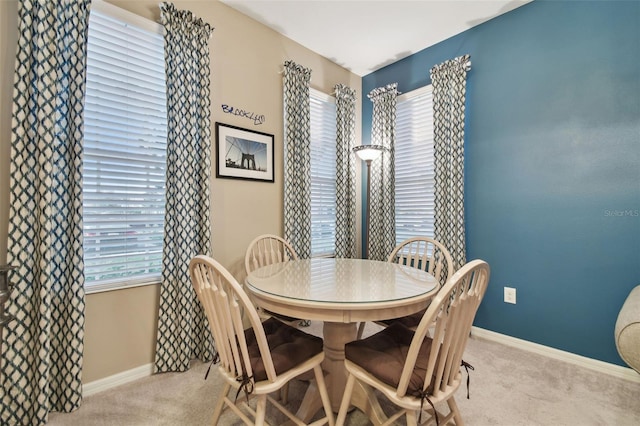 dining room featuring light colored carpet