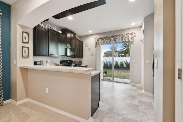 kitchen featuring light colored carpet, kitchen peninsula, and black appliances