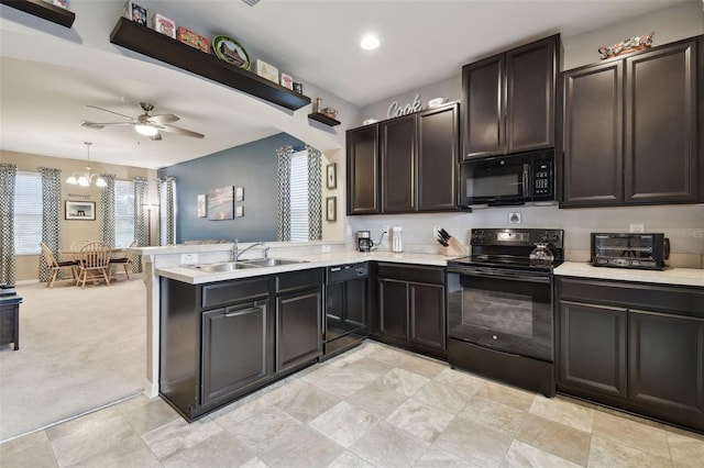 kitchen with sink, decorative light fixtures, light carpet, kitchen peninsula, and black appliances