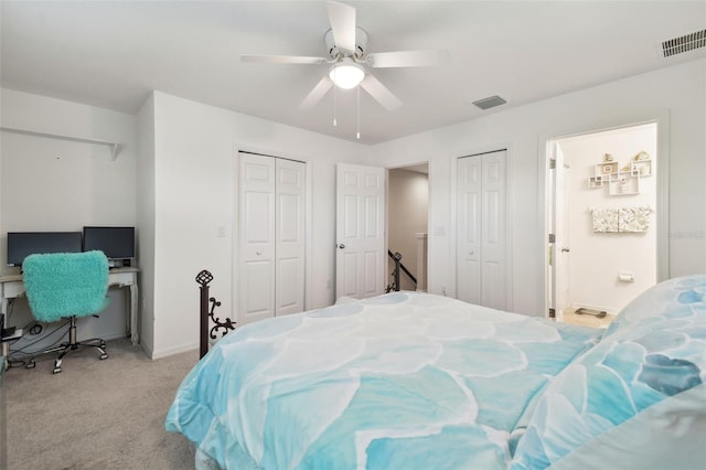 bedroom featuring ceiling fan, light carpet, and two closets