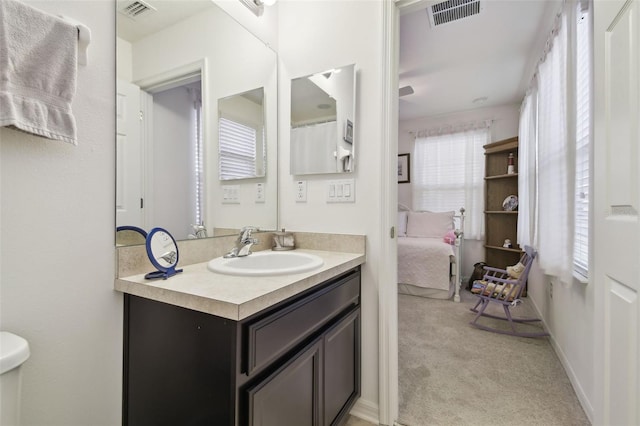 bathroom with vanity, plenty of natural light, and toilet