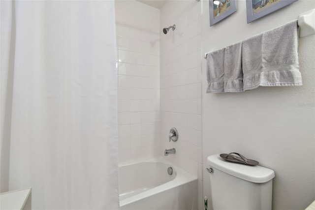 bathroom featuring toilet and shower / bath combo