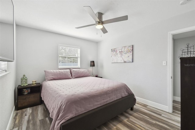 bedroom with ceiling fan and wood-type flooring