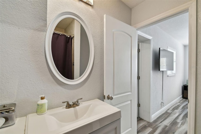 bathroom featuring vanity and hardwood / wood-style floors