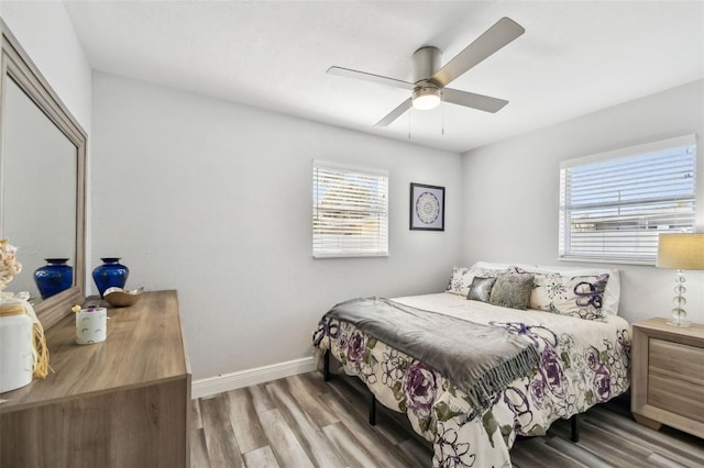 bedroom with ceiling fan and hardwood / wood-style floors