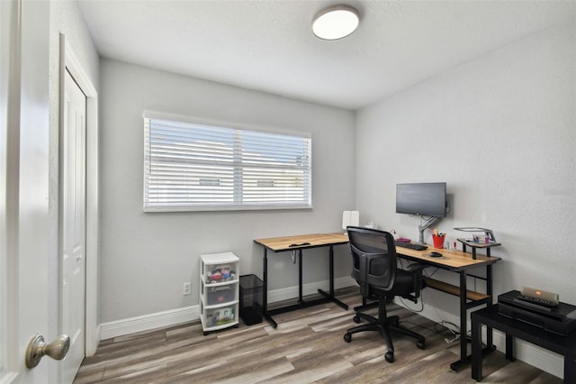 home office with hardwood / wood-style floors