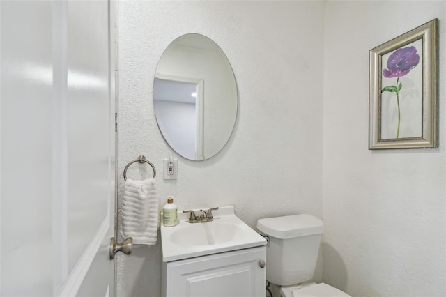 bathroom with toilet and vanity