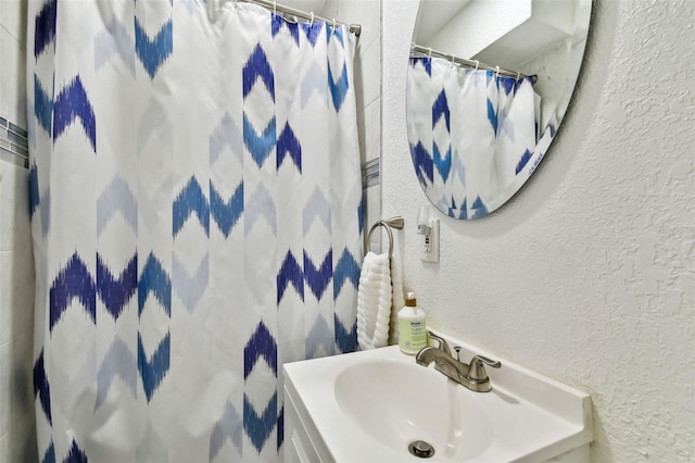 bathroom featuring sink and a shower with shower curtain