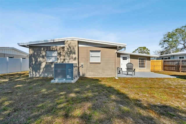 back of house featuring a yard, a patio, and cooling unit