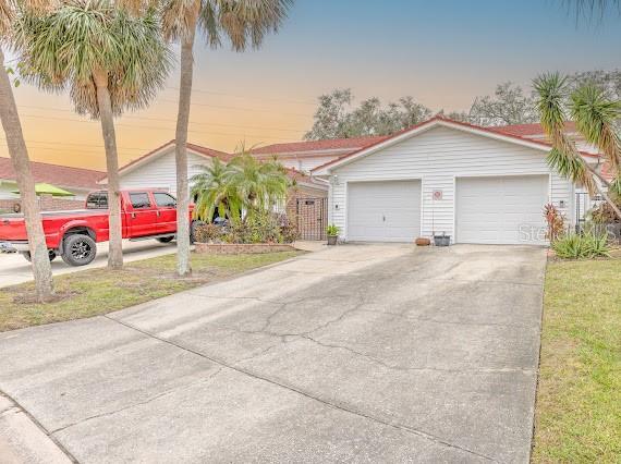 view of front of home featuring a garage and a yard